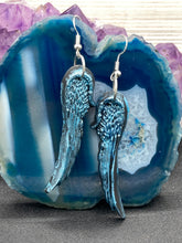 Load image into Gallery viewer, Sparkling light blue angel wings earrings made of polymer clay. These earrings are designed to face forward when worn instead of the front wings showing on the side.