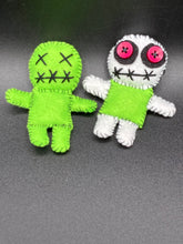 Load image into Gallery viewer, Mini Lime Green And White Voodoo Doll stands at 3 1/2" in height. Torso is lime green with arms, legs and head is all white. He has dark red buttons for eyes. Adorable but with a dash of creepy. Beetlejuice inspired Lime Green Voodoo Doll stands at 3 1/4" in height. All lime green with “x” for eyes and mouth sowed shut. Super spooky but still cute doll.