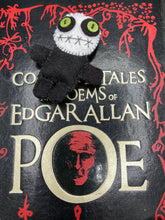 Load image into Gallery viewer, Black and white Voodoo Doll stands at 3" in height. He has an all black body with a white round head. Bulging lime green button eyes and sowed shut mouth to give him a little creepy face of course.