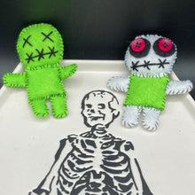 Load image into Gallery viewer, Mini Lime Green And White Voodoo Doll stands at 3 1/2" in height. Torso is lime green with arms, legs and head is all white. He has dark red buttons for eyes. Adorable but with a dash of creepy. Beetlejuice inspired Lime Green Voodoo Doll stands at 3 1/4" in height. All lime green with “x” for eyes and mouth sowed shut. Super spooky but still cute doll.