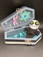 Load image into Gallery viewer, Black and white Voodoo Doll stands at 3" in height. He has an all black body with a white round head. Bulging lime green button eyes and sowed shut mouth to give him a little creepy face of course.