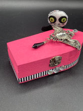 Load image into Gallery viewer, Black and white Voodoo Doll stands at 3" in height. He has an all black body with a white round head. Bulging lime green button eyes and sowed shut mouth to give him a little creepy face of course.