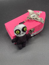 Load image into Gallery viewer, Black and white Voodoo Doll stands at 3" in height. He has an all black body with a white round head. Bulging lime green button eyes and sowed shut mouth to give him a little creepy face of course.