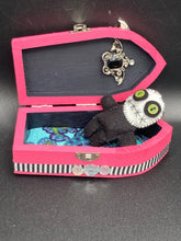 Load image into Gallery viewer, Black and white Voodoo Doll stands at 3" in height. He has an all black body with a white round head. Bulging lime green button eyes and sowed shut mouth to give him a little creepy face of course.