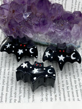 Load image into Gallery viewer, Cute and spooky magnet design to adorn your refrigerator, lockers, workstation, toolbox, or dishwasher. This hand-sculpted clay all black bat statuette has white crescent moon and stars to recreate a starry night sky. H 1” x W 2” x D 1/2”