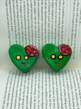 Load image into Gallery viewer, Perfect cute and spooky Halloween item to add to your fridge, locker, cubicle or toolbox. This handcrafted, bright green, heart-shaped magnet features an intricate, exposed brains-inspired zombie design. Measurements: H 1 1/2” x W 1 5/8” x D 1/2”