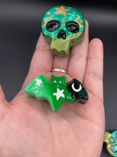 Load image into Gallery viewer, Ideal magnet design to adorn your refrigerator, lockers, workstation, toolbox, or dishwasher. Featuring intricate details and vibrant colors, this hand-painted skull statuette is inspired by nature. Its warm metallic green and gold hues recall the gorgeous tansy beetle, and the addition of moon and stars silhouettes creates a complete celestial motif.  H 1 1/2” x W 1 1/2” x D 3/4”