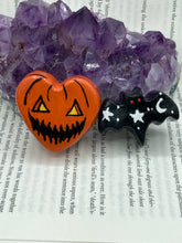 Load image into Gallery viewer, Perfect cute and spooky Halloween item to add to your fridge, locker, cubicle or toolbox. This hand-crafted bright orange heart-shaped magnet showcases a Jack o Lantern inspired design. Black bat magnet with white moons and stars with red eyes.