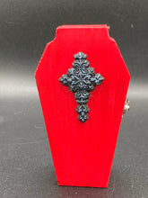 Load image into Gallery viewer, This sleek yet simple design bright red coffin box has an eye-catching detailed floral black and silver cross in the center. Inside, the interior is black with a detailed black and silver fleur de lis pattern.