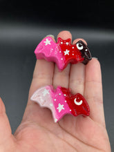 Load image into Gallery viewer, Cute and spooky magnet design to adorn your refrigerator, lockers, workstation, toolbox, or dishwasher. This hand-sculpted clay bat statuette boasts stunning ombre coloration, transitioning from black to dark red to pink and from light pink to dark red to recreate the breathtaking look of a starry night sky. H 1” x W 2” x D 1/2”