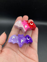 Load image into Gallery viewer, Cute and spooky magnet design to adorn your refrigerator, lockers, workstation, toolbox, or dishwasher. This hand-sculpted clay bat statuette boasts stunning ombre coloration, transitioning from dark to light purple and from light pink to dark red to recreate the breathtaking look of a starry night sky.