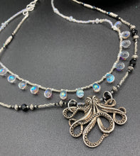Load image into Gallery viewer, This Steampunk Metal Octopus Double Strand Bead Adjustable Necklace is a stylish and unique addition to any collection. Crafted with vivid iridescent teardrop and glass beads, this stylish jewelry also features a highly detailed metal octopus pendant. Strands of beads are designed to interweave without tangling for a truly eye-catching look. Measurements: Necklace measures 16 1/2” adjustable up to 18”