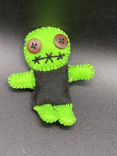 Load image into Gallery viewer, Black And Green Voodoo Doll stand at 3 3/8" in height. Torso is black, while his arms, legs and head is all lime green. He has stylish brown buttons for eyes. Adorable but with a dash of creepy.