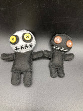 Load image into Gallery viewer, Creepy black and white Voodoo Doll stands tall at 4" in height. He’s all black like a shadow but has a round white head. Bright yellow buttons eyes are perfect to see you better with. Creepy black and white Voodoo Doll stands tall at 4" in height. He’s all black like a shadow but has a round white head. Bright yellow buttons eyes are perfect to see you better with.