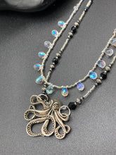 Load image into Gallery viewer, This Steampunk Metal Octopus Double Strand Bead Adjustable Necklace is a stylish and unique addition to any collection. Crafted with vivid iridescent teardrop and glass beads, this stylish jewelry also features a highly detailed metal octopus pendant. Strands of beads are designed to interweave without tangling for a truly eye-catching look. Measurements: Necklace measures 16 1/2” adjustable up to 18”