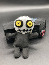 Load image into Gallery viewer, Creepy black and white Voodoo Doll stands tall at 4" in height. He’s all black like a shadow but has a round white head. Bright yellow buttons eyes are perfect to see you better with.