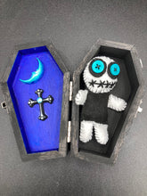 Load image into Gallery viewer, Black and white Voodoo Doll has a black torso, white arms and legs and both round white head with bulging large turquoise buttons, he’s just funny looking. 3 1/2" in height