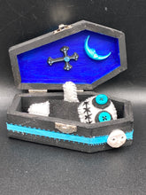 Load image into Gallery viewer, Black and white Voodoo Doll has a black torso, white arms and legs and both round white head with bulging large turquoise buttons, he’s just funny looking. 3 1/2" in height