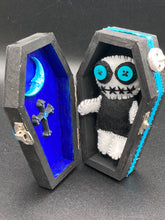Load image into Gallery viewer, Black and white Voodoo Doll has a black torso, white arms and legs and both round white head with bulging large turquoise buttons, he’s just funny looking. 3 1/2" in height