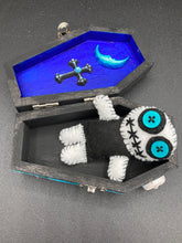 Load image into Gallery viewer, Black and white Voodoo Doll has a black torso, white arms and legs and both round white head with bulging large turquoise buttons, he’s just funny looking. 3 1/2" in height