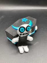 Load image into Gallery viewer, Black and white Voodoo Doll has a black torso, white arms and legs and both round white head with bulging large turquoise buttons, he’s just funny looking. 3 1/2" in height