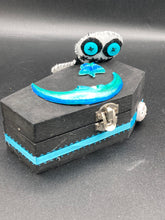 Load image into Gallery viewer, Black and white Voodoo Doll has a black torso, white arms and legs and both round white head with bulging large turquoise buttons, he’s just funny looking. 3 1/2" in height