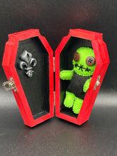 Load image into Gallery viewer, Black And Green Voodoo Doll stand at 3 3/8" in height. Torso is black, while his arms, legs and head is all lime green. He has stylish brown buttons for eyes. Adorable but with a dash of creepy.