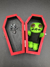 Load image into Gallery viewer, Black And Green Voodoo Doll stand at 3 3/8" in height. Torso is black, while his arms, legs and head is all lime green. He has stylish brown buttons for eyes. Adorable but with a dash of creepy.