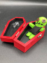 Load image into Gallery viewer, Black And Green Voodoo Doll stand at 3 3/8" in height. Torso is black, while his arms, legs and head is all lime green. He has stylish brown buttons for eyes. Adorable but with a dash of creepy.