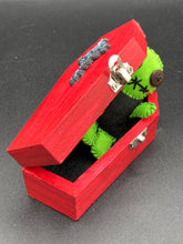 Load image into Gallery viewer, Black And Green Voodoo Doll stand at 3 3/8" in height. Torso is black, while his arms, legs and head is all lime green. He has stylish brown buttons for eyes. Adorable but with a dash of creepy.
