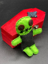 Load image into Gallery viewer, Black And Green Voodoo Doll stand at 3 3/8" in height. Torso is black, while his arms, legs and head is all lime green. He has stylish brown buttons for eyes. Adorable but with a dash of creepy.