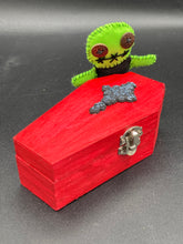 Load image into Gallery viewer, Black And Green Voodoo Doll stand at 3 3/8" in height. Torso is black, while his arms, legs and head is all lime green. He has stylish brown buttons for eyes. Adorable but with a dash of creepy.