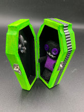 Load image into Gallery viewer, Short and tiny black and purple Voodoo Doll is 3" in height. Torso is purple while legs and arms and head are all black like the night. He has matching purple buttons for eyes and has a sowed shut mouth.