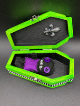 Load image into Gallery viewer, Short and tiny black and purple Voodoo Doll is 3" in height. Torso is purple while legs and arms and head are all black like the night. He has matching purple buttons for eyes and has a sowed shut mouth.