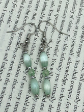 Load image into Gallery viewer, Dainty pastel green glass beaded earringsThese dainty pastel green glass beaded earrings add a unique and eye-catching touch to any look, making them the perfect bohemian accessory. Their shabby boho chic design is both comfortable and elegant, making them the ideal choice for any occasion. Measurements: 1 1/4” in length
