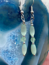 Load image into Gallery viewer, Dainty pastel green glass beaded earringsThese dainty pastel green glass beaded earrings add a unique and eye-catching touch to any look, making them the perfect bohemian accessory. Their shabby boho chic design is both comfortable and elegant, making them the ideal choice for any occasion. Measurements: 1 1/4” in length