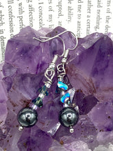 Load image into Gallery viewer, These stunning hematite and glass beaded earrings are a perfect combination of shabby boho chic and bohemian style. The round hematite beads are beautifully complemented by the light blue triangle shaped glass beads, for an eye-catching accessory that is sure to draw attention.  Measurements: 1 1/4” in length