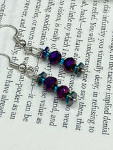 Load image into Gallery viewer, These rainbow hematite and dark purple glass beaded earrings are the ideal accessory for bohemian summer looks, providing a touch of chic elegance to hippie and nature-inspired styles. Measurements: 1” in length