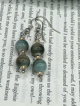 Load image into Gallery viewer, These mossy green round ceramic beads are paired with gold tone glass beads for an earthy and stylish set of earrings. Measurements: 1"