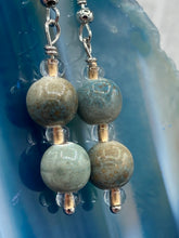 Load image into Gallery viewer, These mossy green round ceramic beads are paired with gold tone glass beads for an earthy and stylish set of earrings. Measurements: 1"