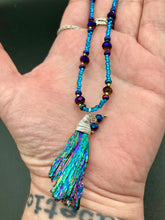 Load image into Gallery viewer, Rainbow Kyanite Wired Stone With Multi-Color Glass Beads Necklace. I used a combination of deep purples, turquoise blues, and golds to really capture the essence of this celestial galaxy stone. This beautiful necklace and rainbow kyanite pendant is a must have jewelry piece to add to your collection. Measurements: Necklace is 16” adjustable up to 18" in length - pendant is 2” Height