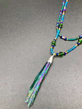 Load image into Gallery viewer, This Celestial and Galaxy Vibe Necklace features a 2 1/2" long Rainbow Kyanite Wired Stone pendant and two strands of multi-color glass beaded necklaces. The glass beads are an eclectic mix of sizes and shapes, including rectangular hematite beads, creating a shimmery, bold display of purples, blues, greens and golds. This necklace truly captures the essence of this celestial galaxy stone.Necklace is 15 1/2” in length can be adjusted to 18" in length