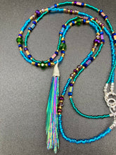 Load image into Gallery viewer, This Celestial and Galaxy Vibe Necklace features a 2 1/2" long Rainbow Kyanite Wired Stone pendant and two strands of multi-color glass beaded necklaces. The glass beads are an eclectic mix of sizes and shapes, including rectangular hematite beads, creating a shimmery, bold display of purples, blues, greens and golds. This necklace truly captures the essence of this celestial galaxy stone.Necklace is 15 1/2” in length can be adjusted to 18" in length