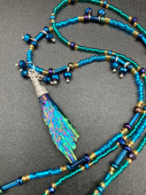 Load image into Gallery viewer, This celestial and galaxy goddess necklace features two strands of glass beading and a captivating Kyanite wired stone pendant. Its mixture of shimmering purples, blues, greens, and golds is truly striking and provides an alluring look like no other. Add this bold and beautiful jewelry piece to your collection today for a statement look that truly stands out. Necklace is 15” in length, can be adjusted to 18"