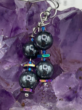 Load image into Gallery viewer, These earrings feature two round, beautiful hematite beads and hexagon-shaped rainbow hematite beads.   Measurements: 1 1/4” in length
