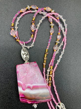 Load image into Gallery viewer, This large agate pendant features a variety of pink hues, from light to dark, and is accompanied by two strands of glass beaded necklaces with pink, silver, gold, and clear beads. The combination of colors creates a stunning and vibrant look, perfect for accessorizing any summer look. Measurements: Necklace is 15” adjustable up to 18" in length