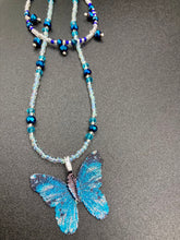 Load image into Gallery viewer, This Sterling Silver Bright Sky Blue and Silver Butterfly Pendant is detailed with a basil leaf motif. With vibrant hues of blue and silver, the pendant is complimented by multi-color glass beads to create the ideal summer jewelry piece.  Measurements:  Necklace is 16 1/2”adjustable up to 18"