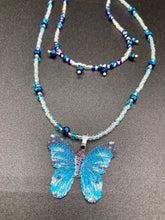 Load image into Gallery viewer, This Sterling Silver Bright Sky Blue and Silver Butterfly Pendant is detailed with a basil leaf motif. With vibrant hues of blue and silver, the pendant is complimented by multi-color glass beads to create the ideal summer jewelry piece.  Measurements:  Necklace is 16 1/2”adjustable up to 18"