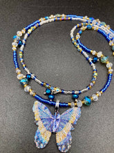 Load image into Gallery viewer, This Sterling Silver Dark Blue, Silver and Gold Butterfly Pendant is handcrafted from a basil leaf, and is meticulously painted in brilliant blues and silver. A range of multi-colored glass beads from deep blue to pale silver and gold tones combine to create a stunning lapis stone-like effect. This nature-inspired jewelry piece is perfect for adding a touch of summery style to any look.  Measurements:   Necklace is 15 1/2” adjustable up to 18"