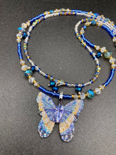 Load image into Gallery viewer, This Sterling Silver Dark Blue, Silver and Gold Butterfly Pendant is handcrafted from a basil leaf, and is meticulously painted in brilliant blues and silver. A range of multi-colored glass beads from deep blue to pale silver and gold tones combine to create a stunning lapis stone-like effect. This nature-inspired jewelry piece is perfect for adding a touch of summery style to any look.  Measurements:   Necklace is 15 1/2” adjustable up to 18"